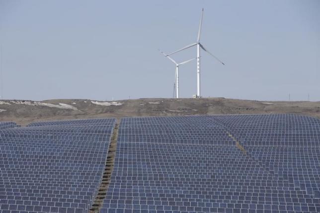 File picture of wind turbines and solar panels at a wind and solar energy storage and transmission power station from State Grid Corporation of China, in Zhangjiakou of Hebei province